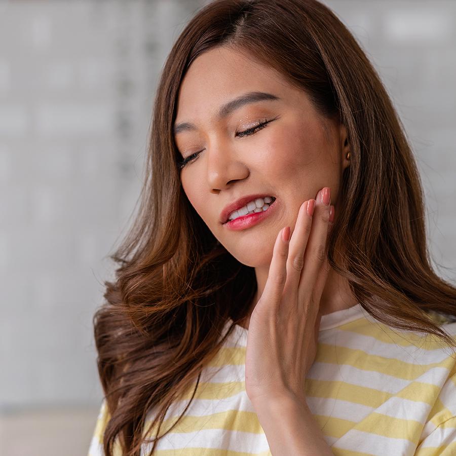 Woman experiencing pain in a dental emergency near Santa Maria, CA